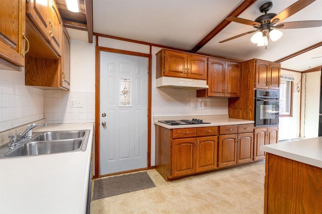 kitchen with a ceiling fan, a sink, black oven, under cabinet range hood, and stovetop