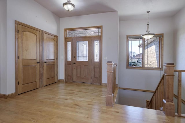 entryway featuring light wood-type flooring and baseboards