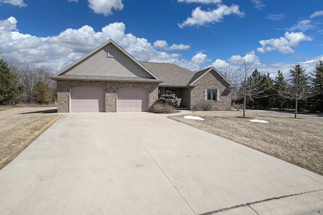 view of front of property featuring brick siding, concrete driveway, and an attached garage