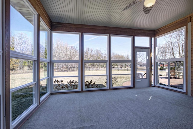 unfurnished sunroom with ceiling fan