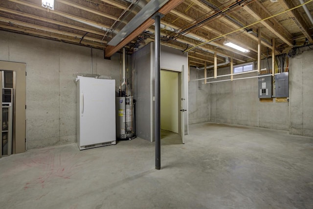 basement featuring electric panel, water heater, and freestanding refrigerator