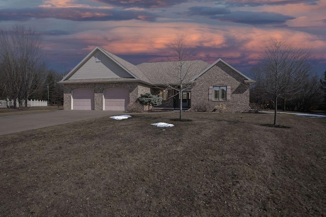 view of front of house featuring concrete driveway, a garage, brick siding, and a front yard