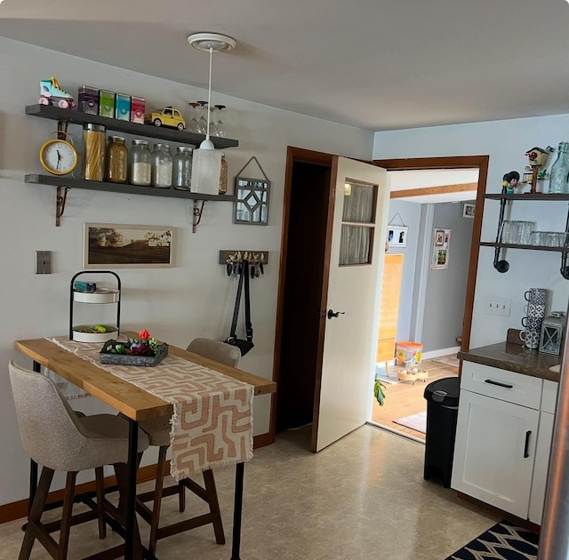 dining space featuring baseboards