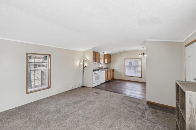 unfurnished living room with crown molding, dark carpet, vaulted ceiling, a notable chandelier, and a textured ceiling