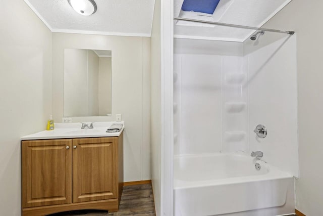 full bath with vanity, bathing tub / shower combination, wood finished floors, and a textured ceiling