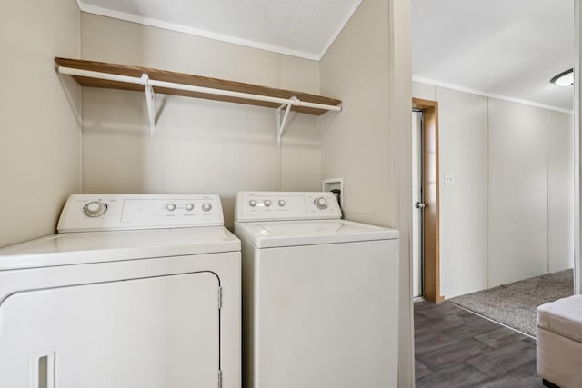 clothes washing area with laundry area, washing machine and dryer, and dark wood-type flooring