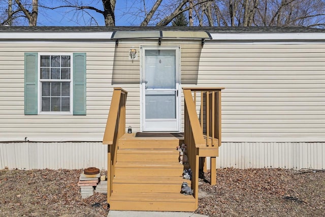 entrance to property with roof with shingles