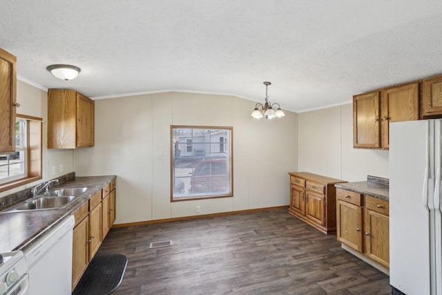 kitchen with white appliances, visible vents, dark wood-type flooring, and a sink