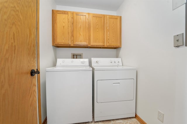 washroom featuring cabinet space and washing machine and dryer