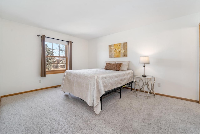 carpeted bedroom featuring baseboards