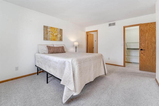 bedroom featuring visible vents, carpet floors, and baseboards