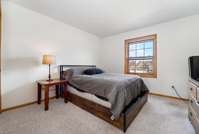 bedroom with baseboards and carpet