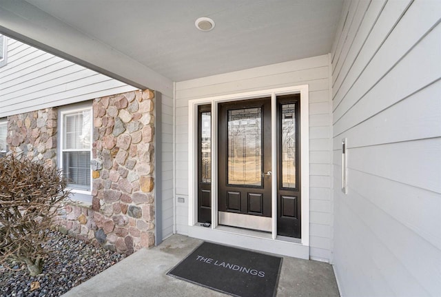 property entrance featuring stone siding