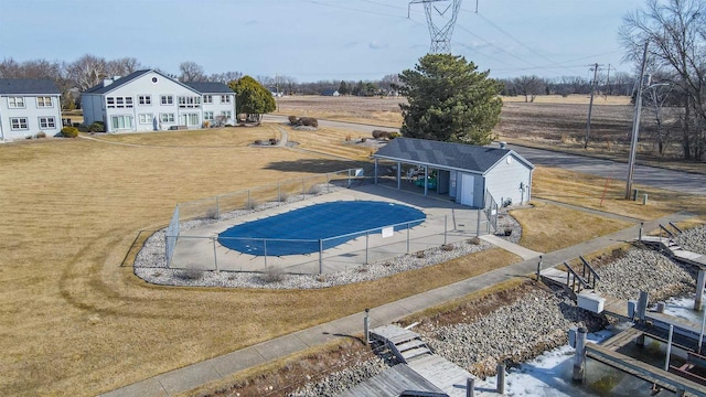 view of pool featuring an outdoor structure, a yard, and fence