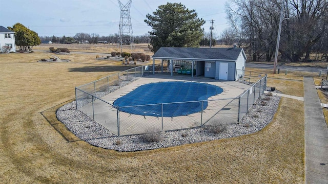 pool featuring a patio, fence, and a lawn