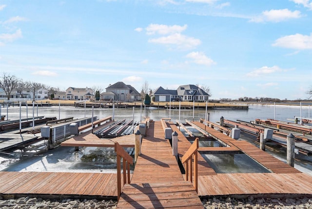 dock area with a residential view, a water view, and boat lift