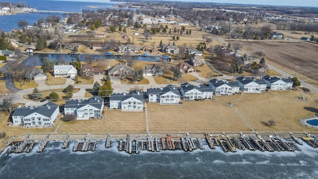 drone / aerial view with a residential view and a water view