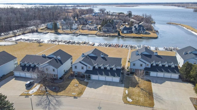 drone / aerial view with a residential view and a water view