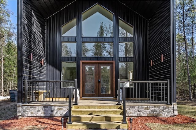 doorway to property featuring french doors and stone siding