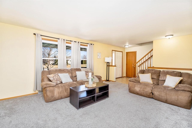 living room featuring stairway, baseboards, and carpet flooring