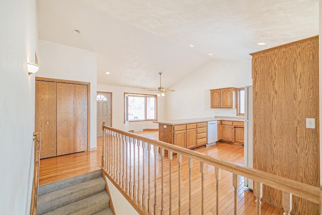 stairs with lofted ceiling, recessed lighting, wood finished floors, and ceiling fan