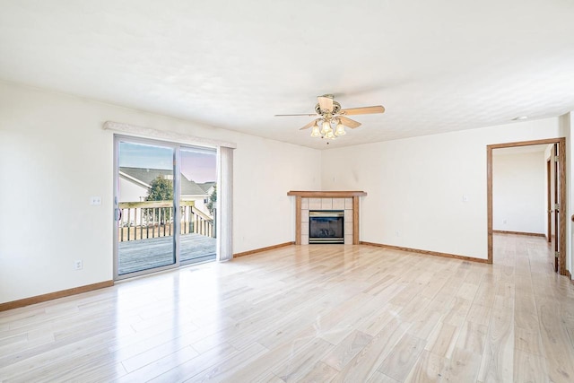 unfurnished living room with baseboards, a ceiling fan, and light wood finished floors