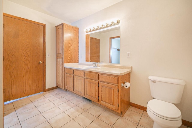 bathroom with vanity, visible vents, baseboards, tile patterned flooring, and toilet