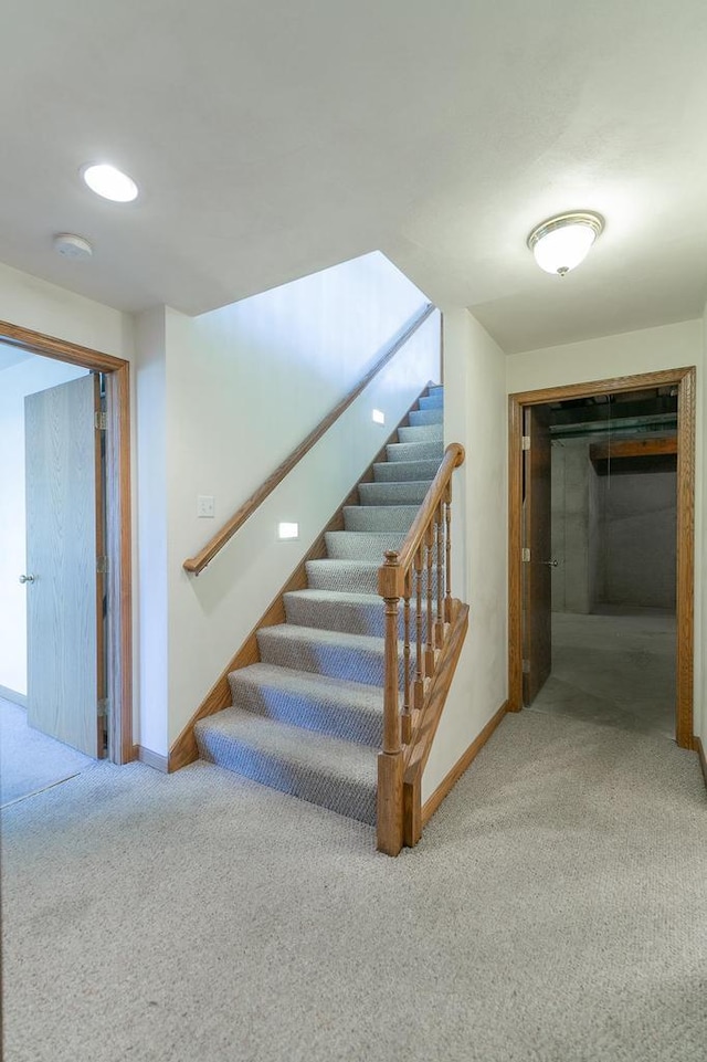 stairs with baseboards and carpet floors