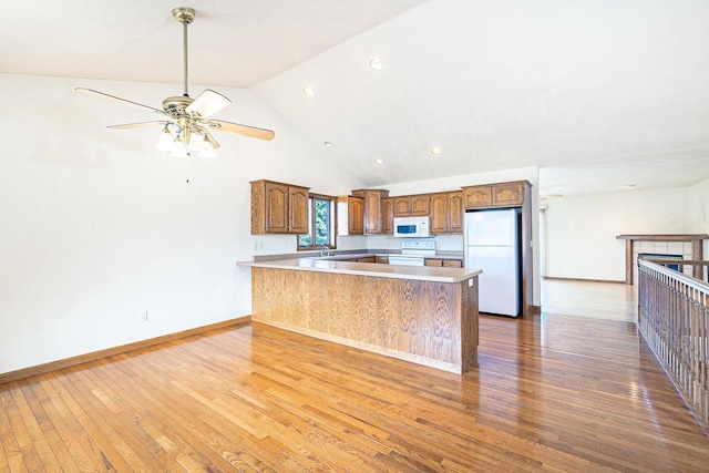 kitchen with white appliances, baseboards, ceiling fan, and hardwood / wood-style flooring