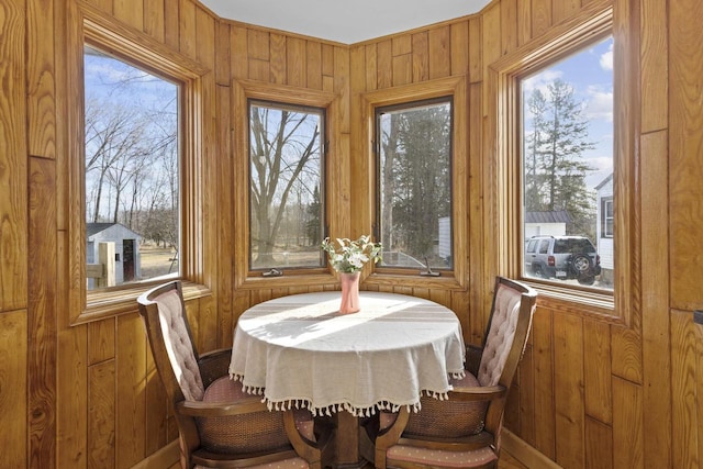 dining space featuring wood walls