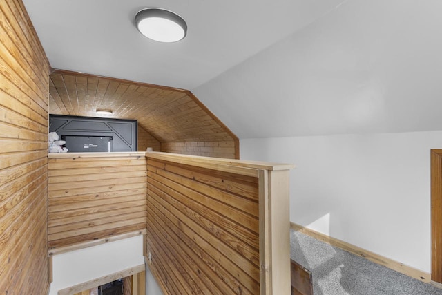 interior space with wood walls and vaulted ceiling