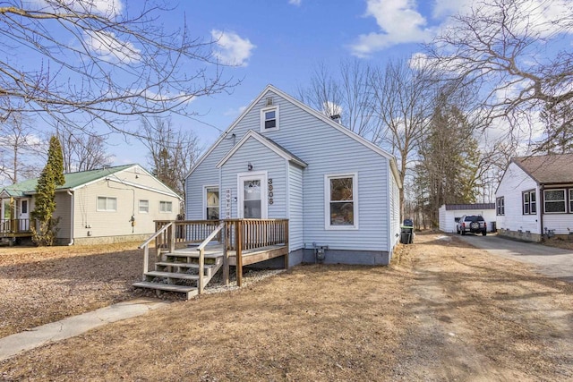 view of front of property with a wooden deck and a garage