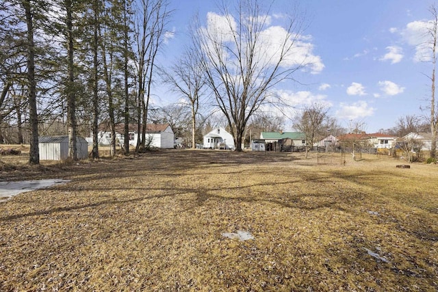 view of yard featuring a storage shed and an outdoor structure