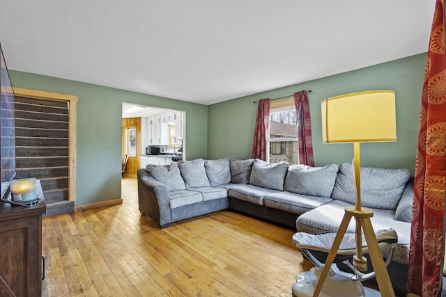 living room featuring baseboards and light wood-style floors