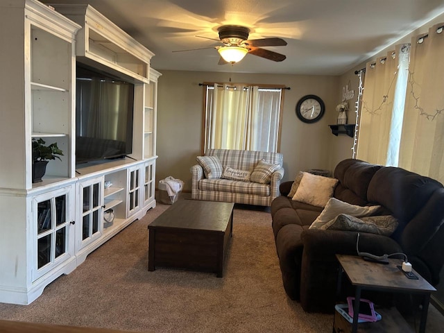 carpeted living area featuring a ceiling fan