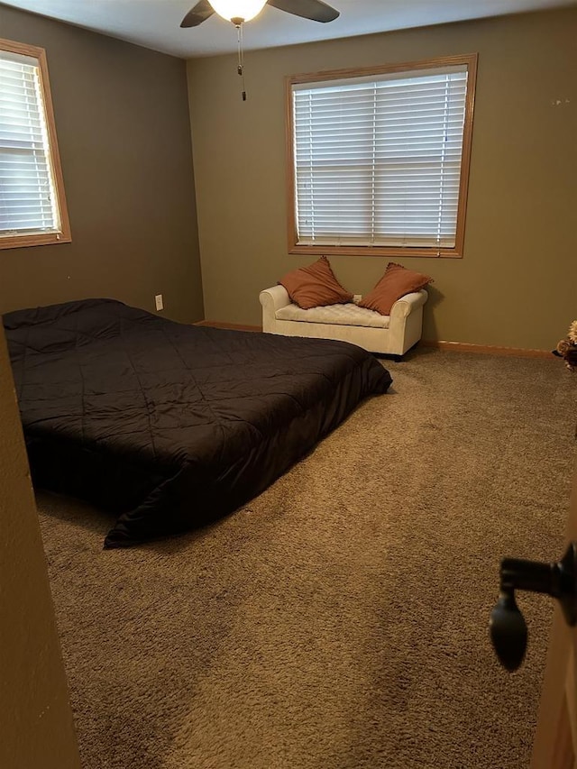 carpeted bedroom with baseboards and a ceiling fan