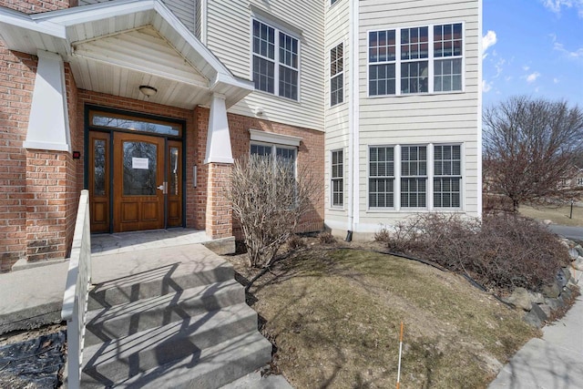 doorway to property with brick siding