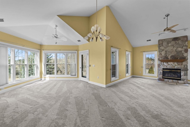 unfurnished living room featuring a stone fireplace, carpet floors, and ceiling fan