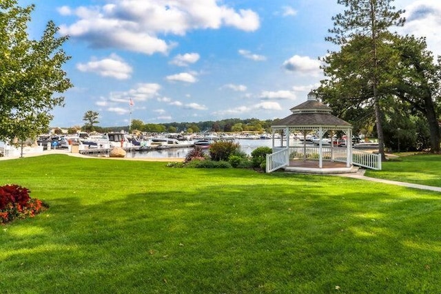 exterior space with a gazebo, a yard, and a water view