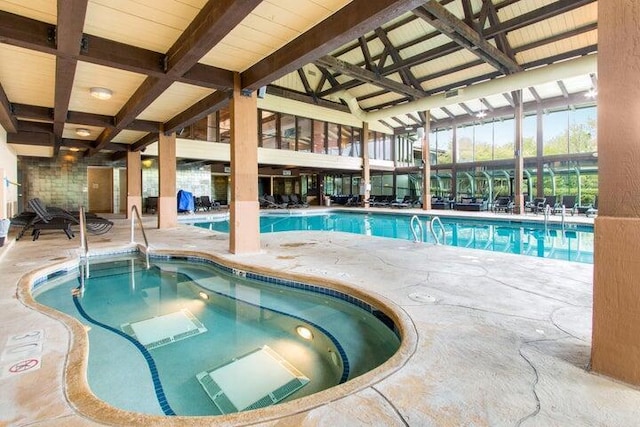 community pool with a patio and an indoor in ground hot tub