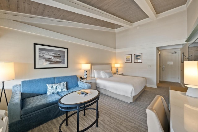 bedroom featuring beamed ceiling, carpet flooring, wood ceiling, and baseboards