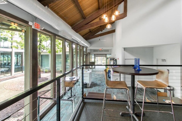 sunroom featuring wooden ceiling and lofted ceiling with beams