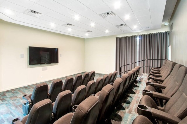 cinema room featuring visible vents and baseboards