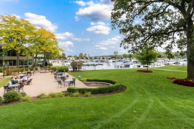 view of community featuring a water view and a lawn