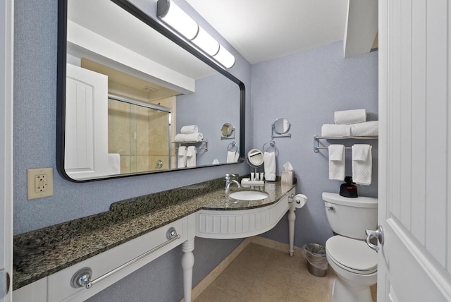 bathroom with vanity, baseboards, a stall shower, tile patterned floors, and toilet