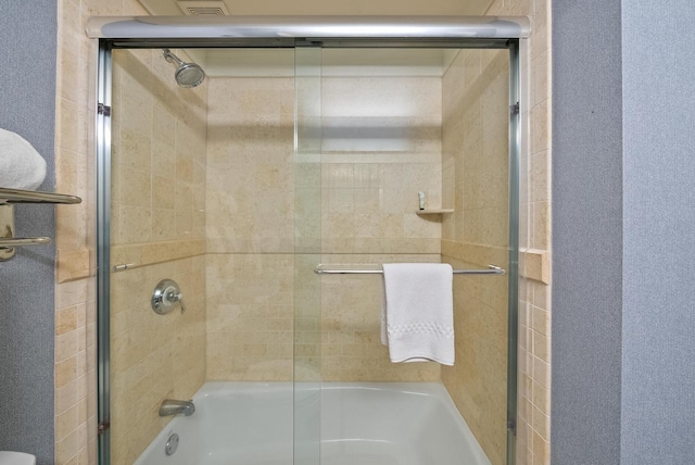 full bathroom featuring bath / shower combo with glass door