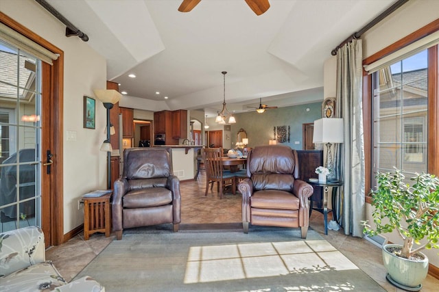 living room featuring recessed lighting, ceiling fan with notable chandelier, and baseboards