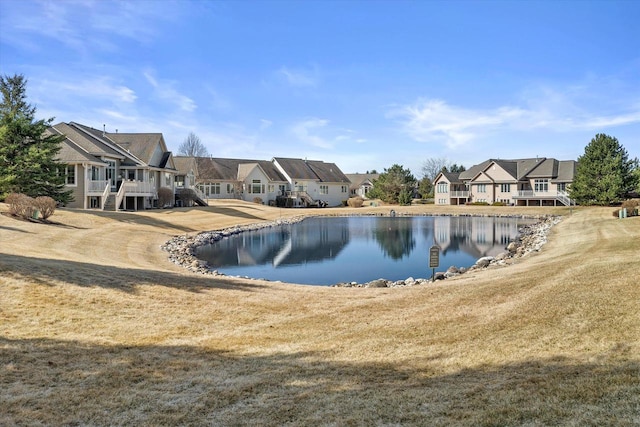 view of pool with a residential view and a water view