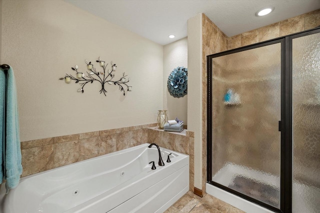 full bath with tile patterned floors, a jetted tub, recessed lighting, and a stall shower