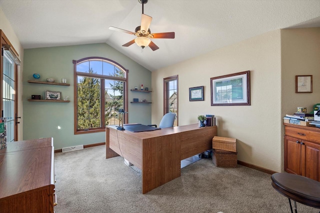 office area with a ceiling fan, visible vents, carpet floors, baseboards, and lofted ceiling